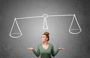 woman looking at a scale (hormone balancing)