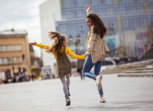 energetic mom and kid skipping
