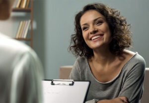 smiling woman talking to a doctor