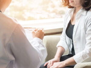 doctor with patient describing weight loss barriers