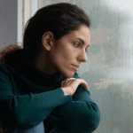 Depressed woman looking out the window