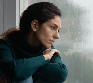 Depressed woman looking out the window